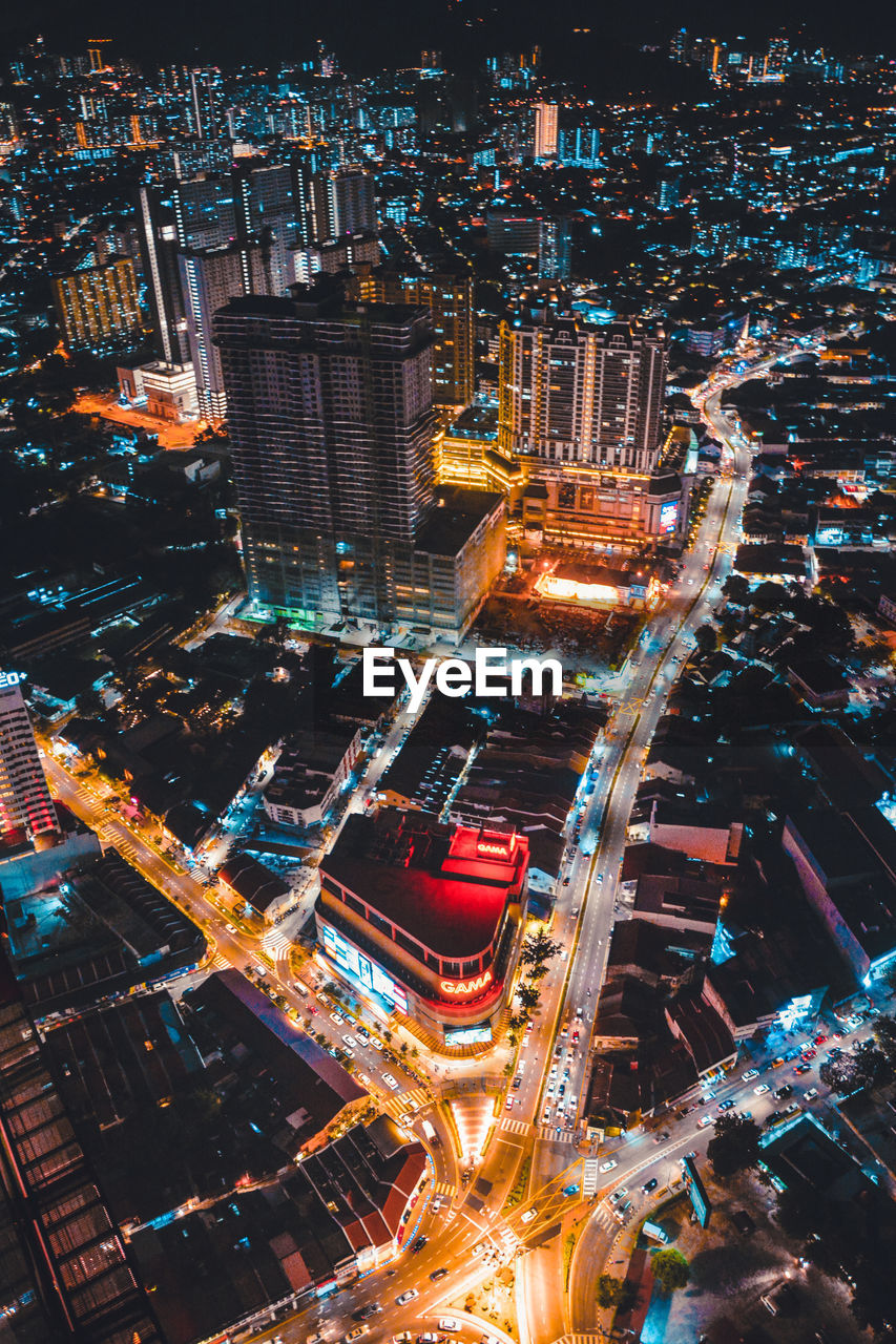 HIGH ANGLE VIEW OF ILLUMINATED CITY BUILDINGS