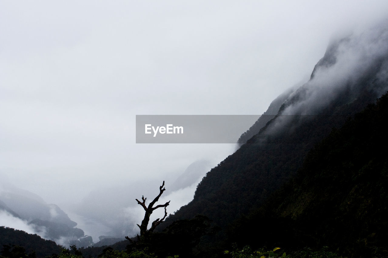 SCENIC VIEW OF MOUNTAINS AGAINST SKY DURING FOGGY WEATHER