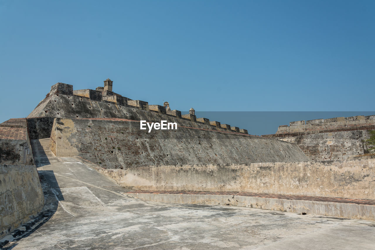 Low angle view of fort against blue sky