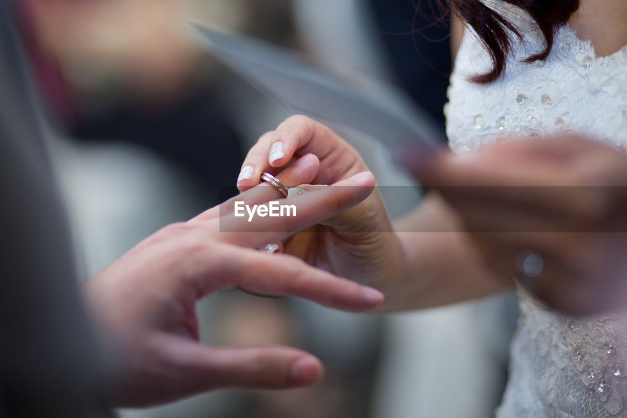 Close-up of couple holding hands