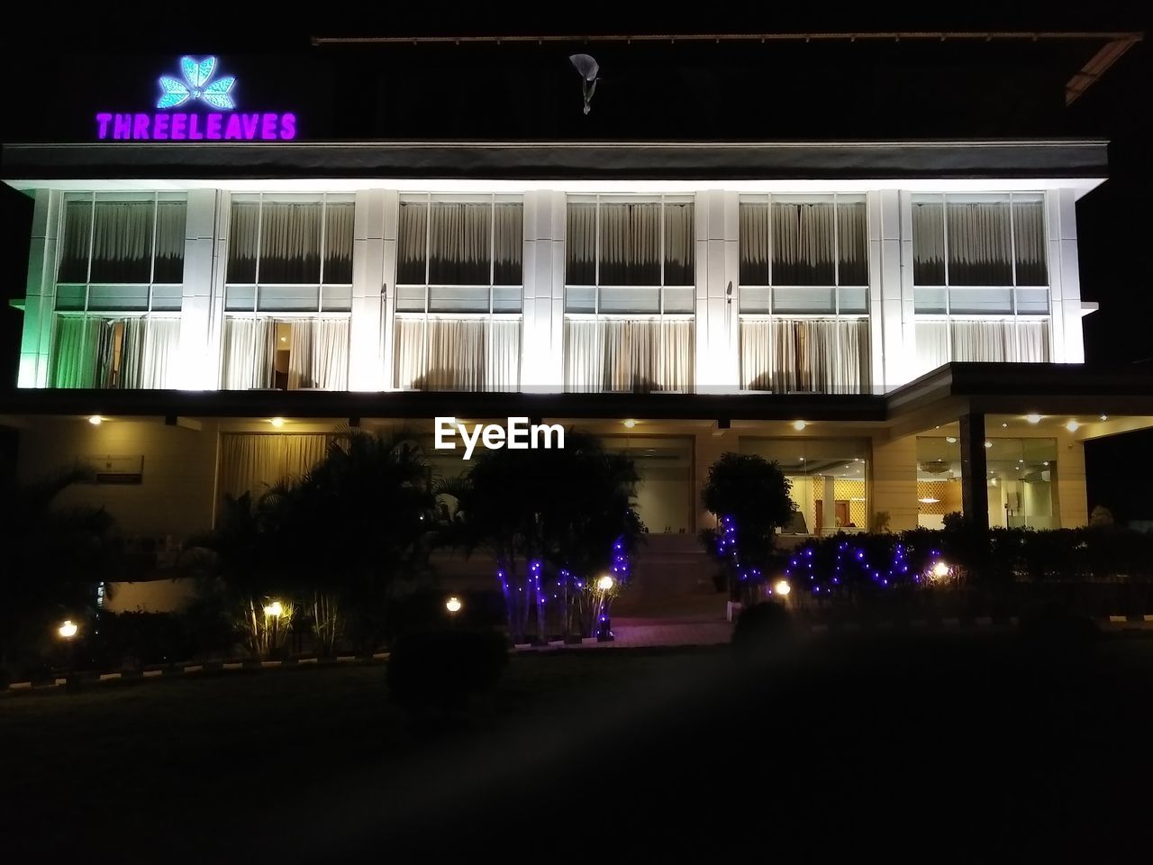 VIEW OF ILLUMINATED BUILDING AT NIGHT