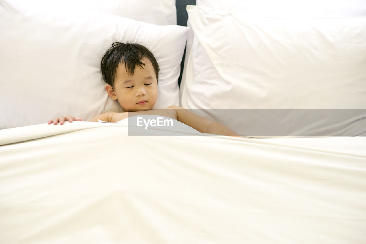 Boy sleeping in bed