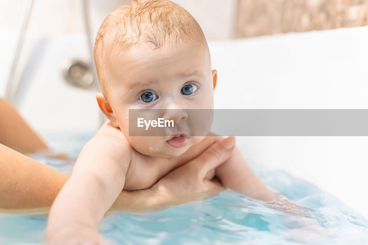Close-up of cute baby girl in bathtub
