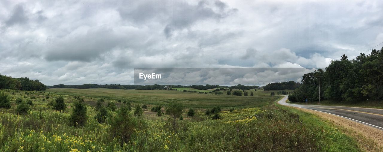 Panoramic shot of country road along landscape