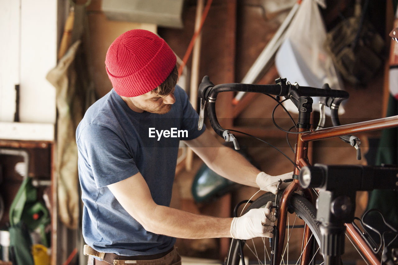 Mechanic repairing bicycle at workshop