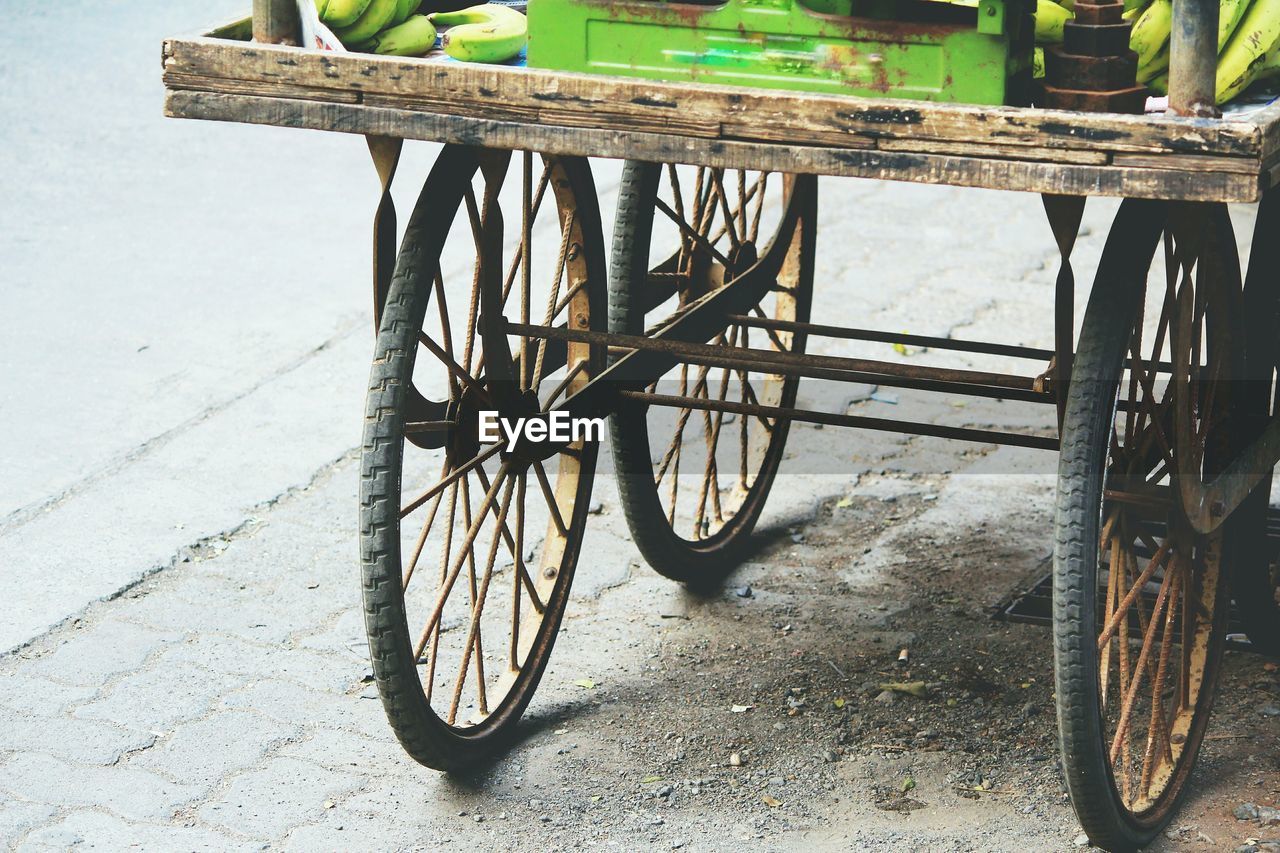 High angle view of cart wheels on road