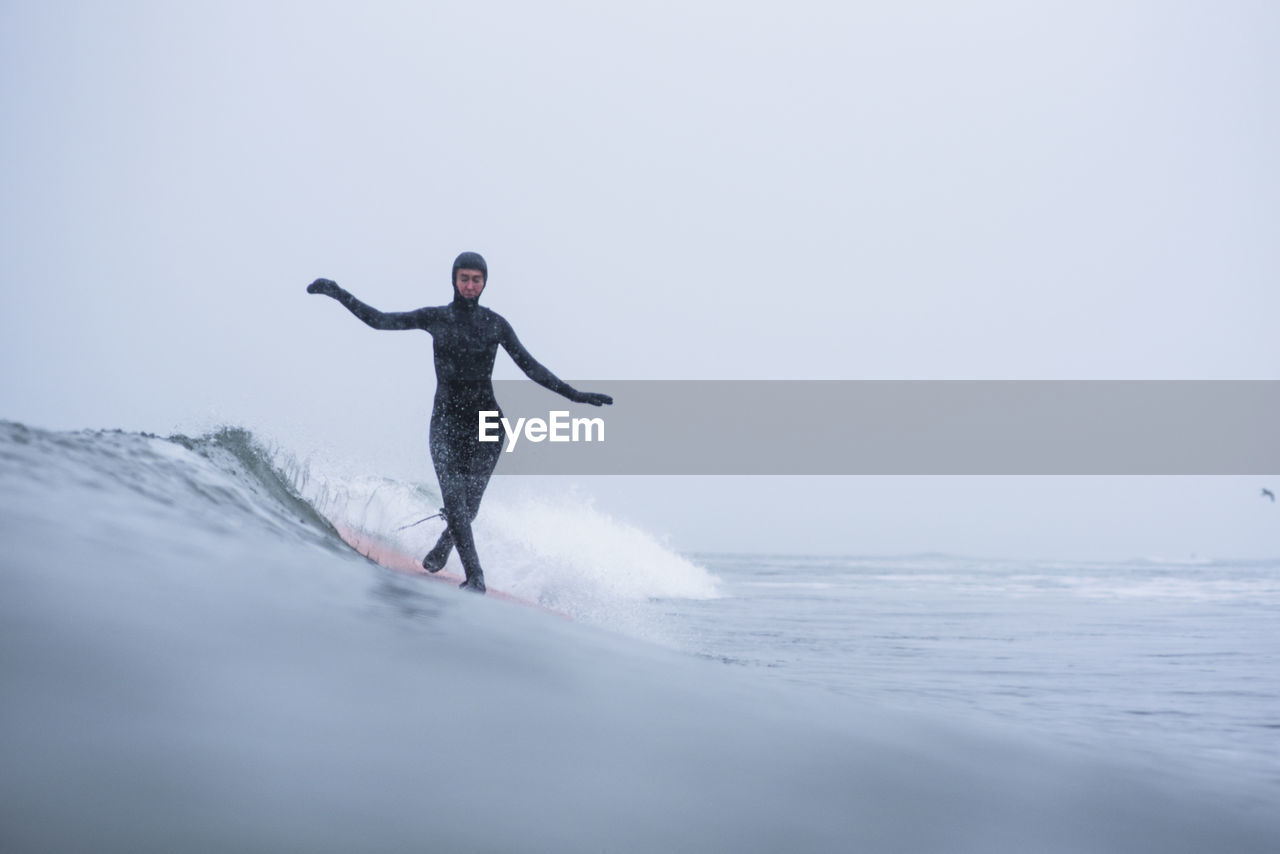 Woman surfing during winter snow