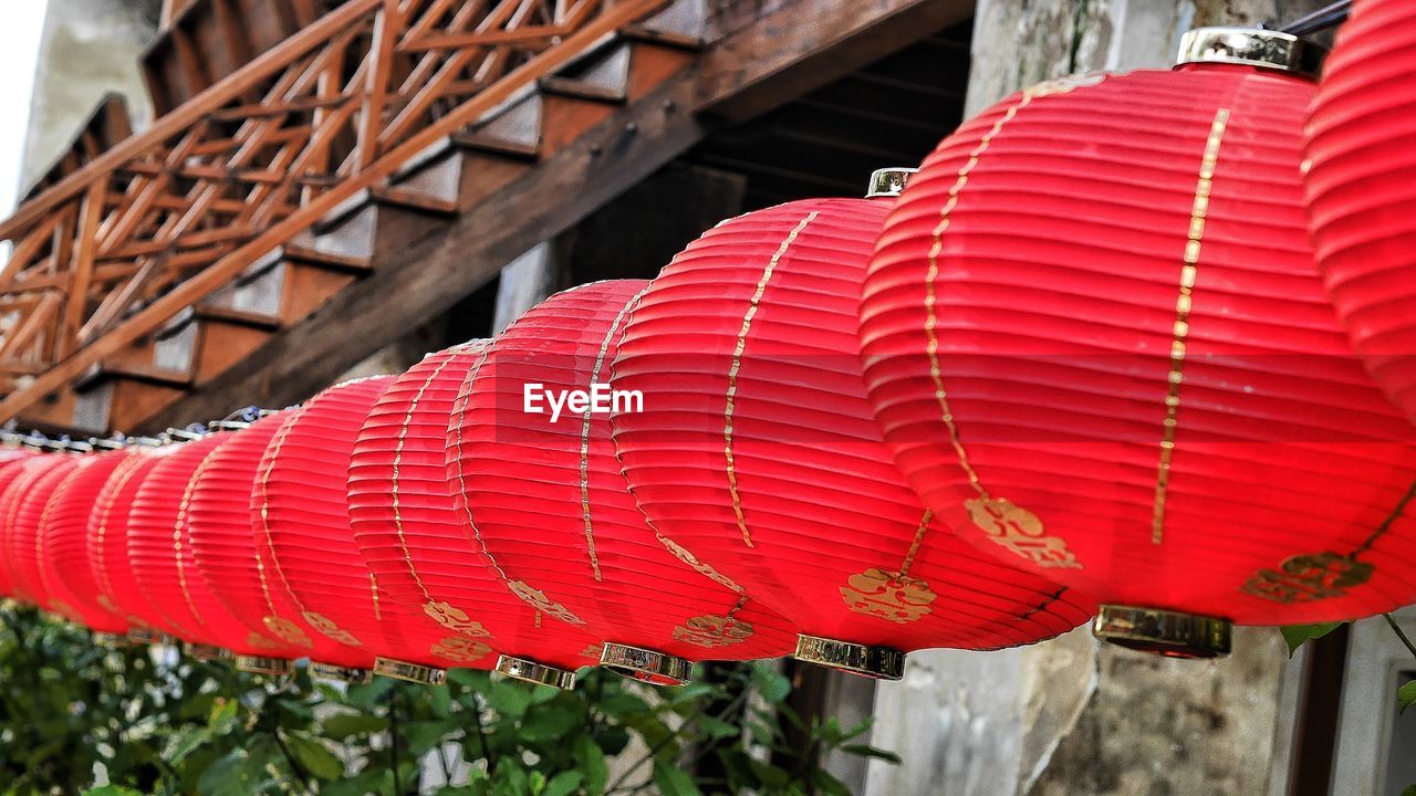 Red lanterns hanging against built structure