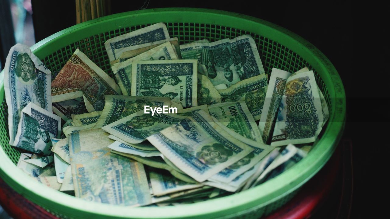 High angle view of basket with paper currency
