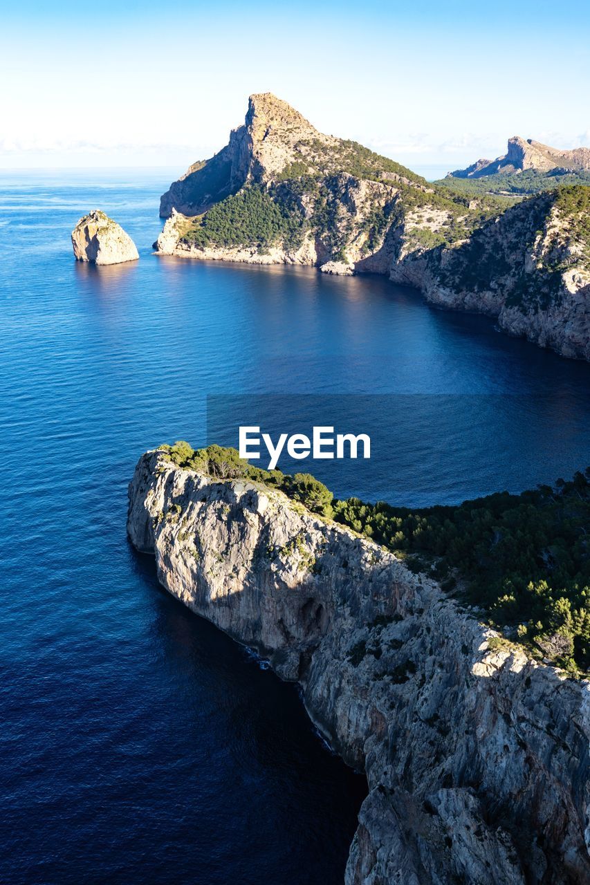 Scenic view of rocks in sea against sky