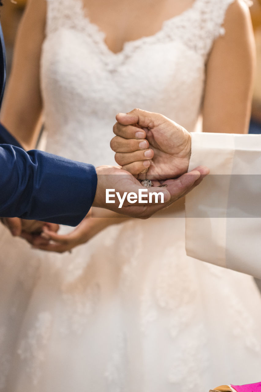 Priest blessing couple during wedding ceremony