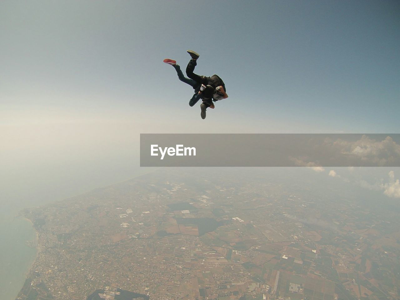 LOW ANGLE VIEW OF WOMAN JUMPING