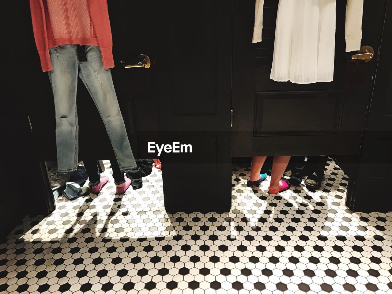 Low section of people in fitting rooms