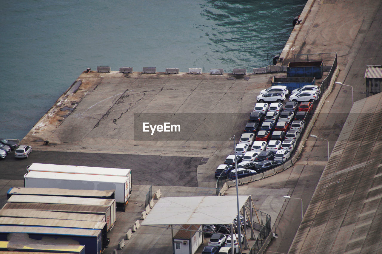 High angle view of factory buildings in city at commercial dock 