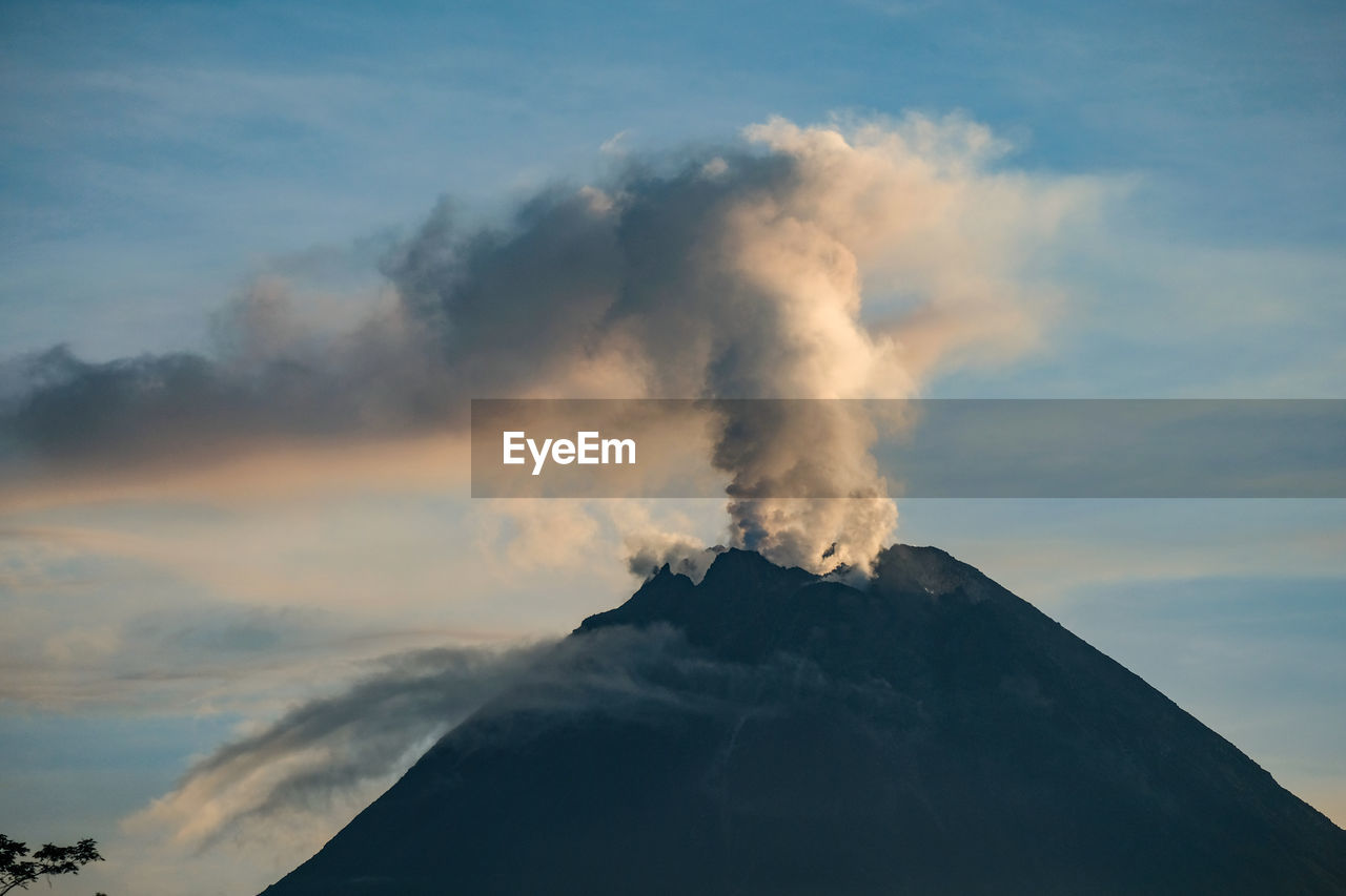 SMOKE EMITTING FROM VOLCANIC MOUNTAINS AGAINST SKY