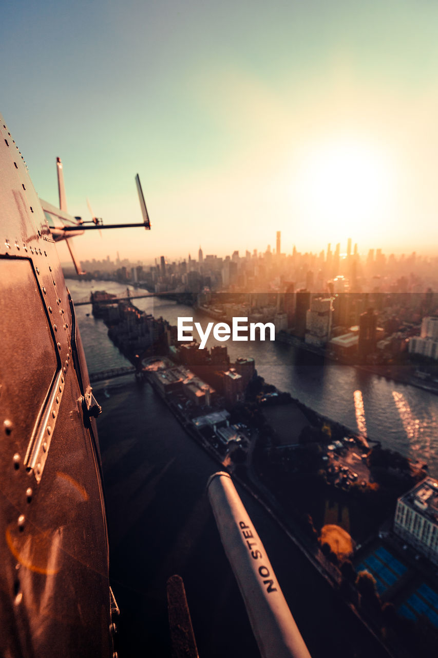 Aerial view of city buildings against sky during sunset new york city