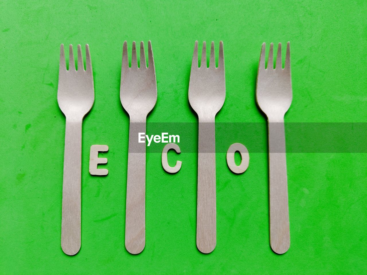 fork, eating utensil, silverware, kitchen utensil, green, household equipment, tableware, no people, table knife, tool, studio shot, food and drink, knife, group of objects, indoors, spoon, food, directly above, metal, colored background, side by side, close-up, still life, in a row, variation, arrangement