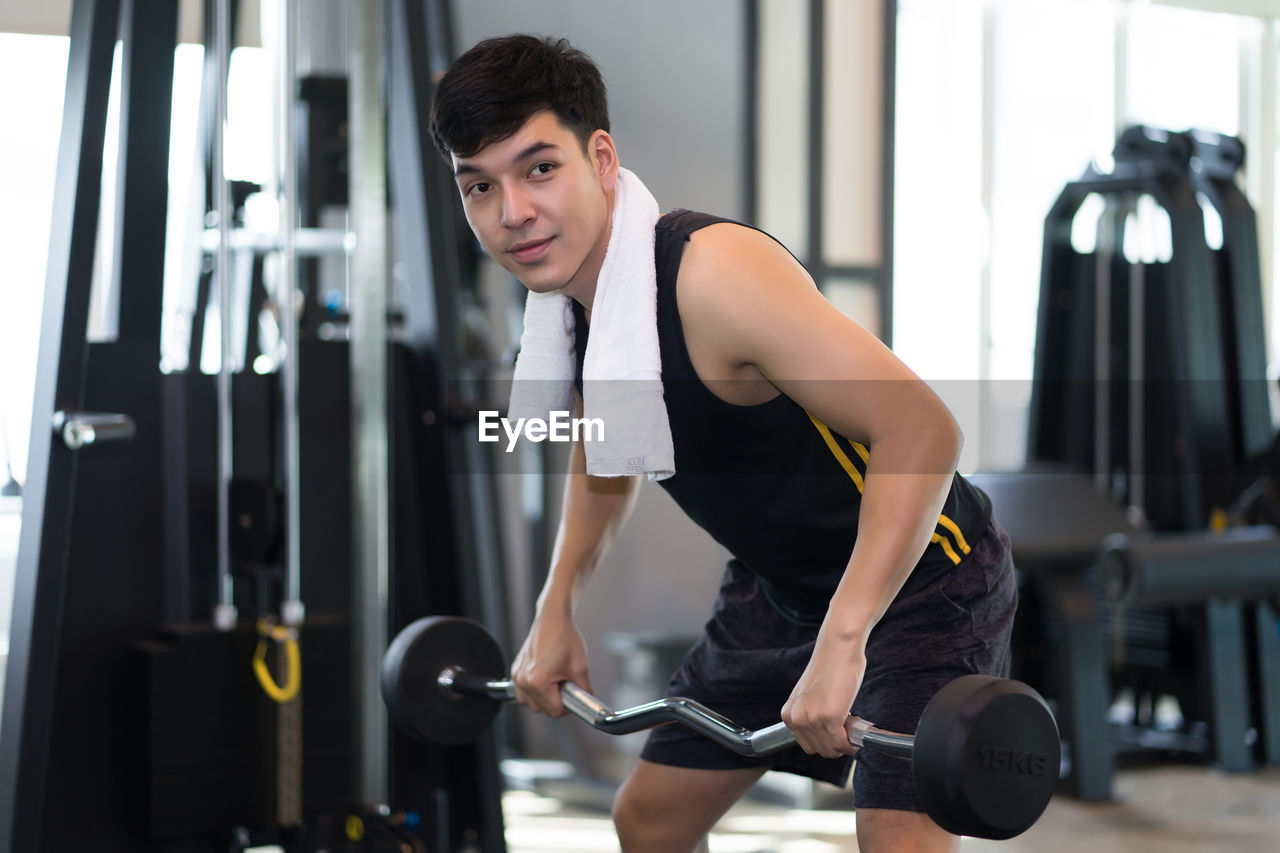 Young man exercising in gym