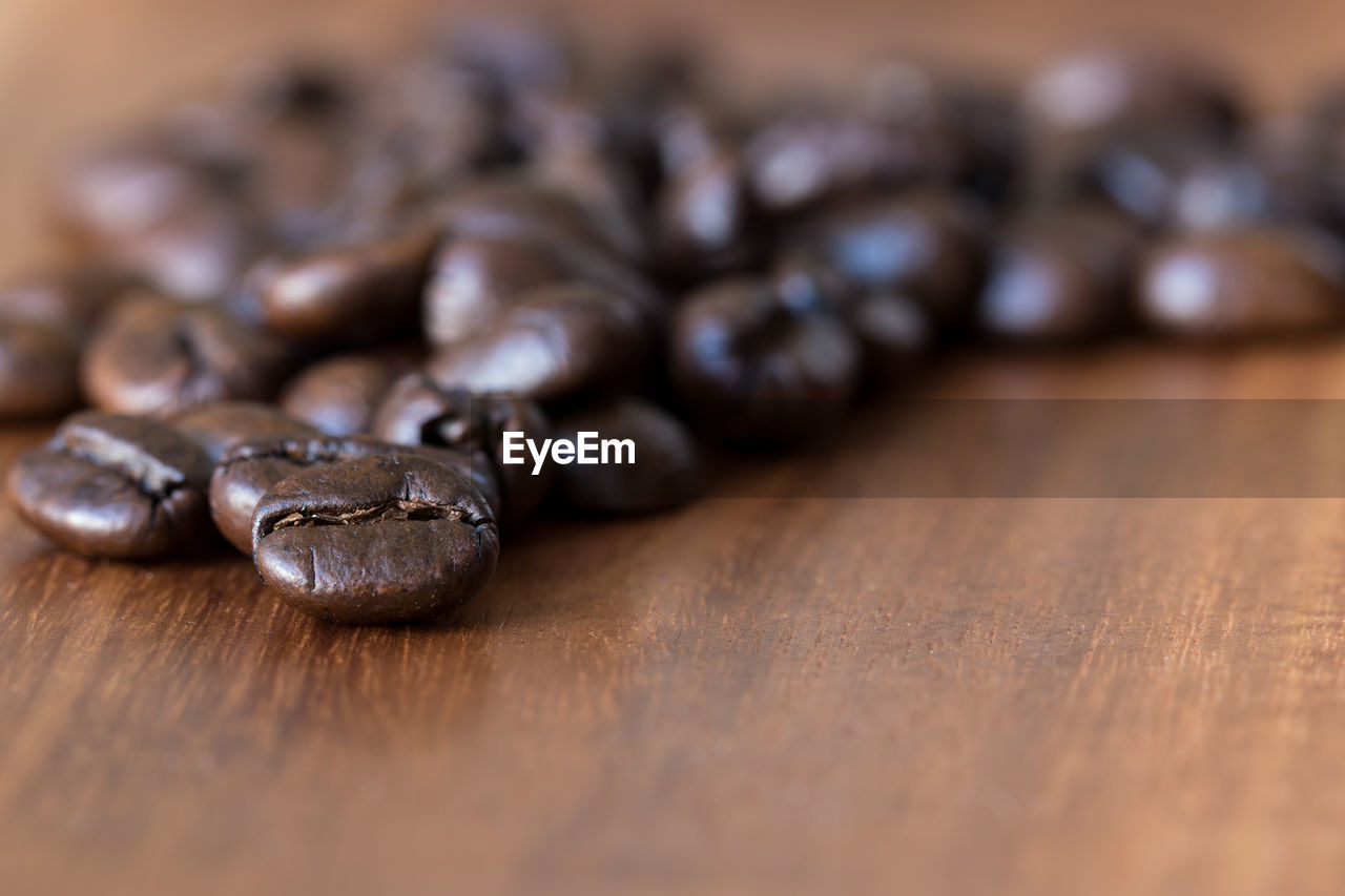 Close-up of roasted coffee beans on table