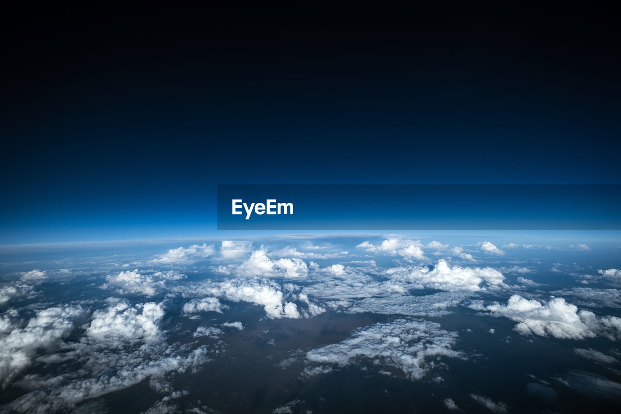 HIGH ANGLE VIEW OF CLOUDS OVER LANDSCAPE