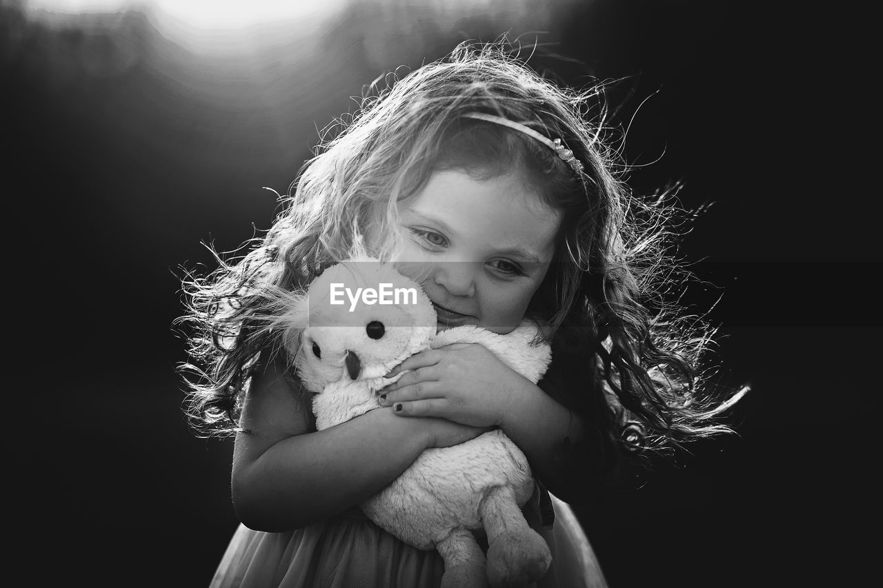 Portrait of girl holding toy