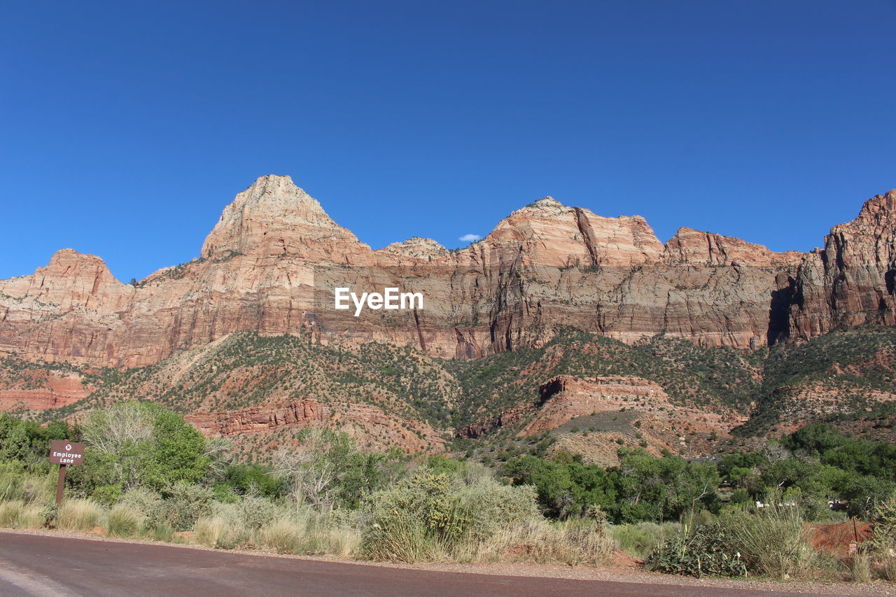 Scenic view of rocky mountains against clear blue sky