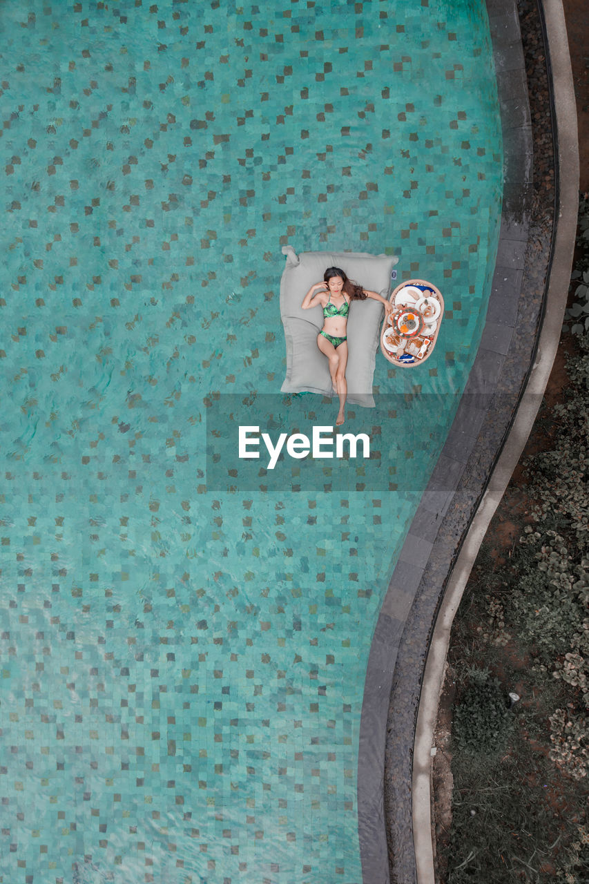 High angle view of woman swimming in pool