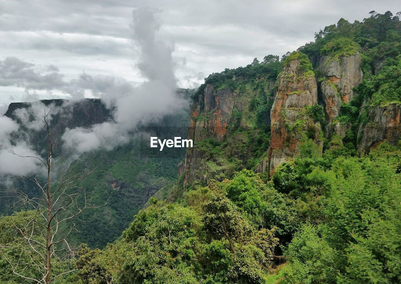 Scenic view of mountains against cloudy sky