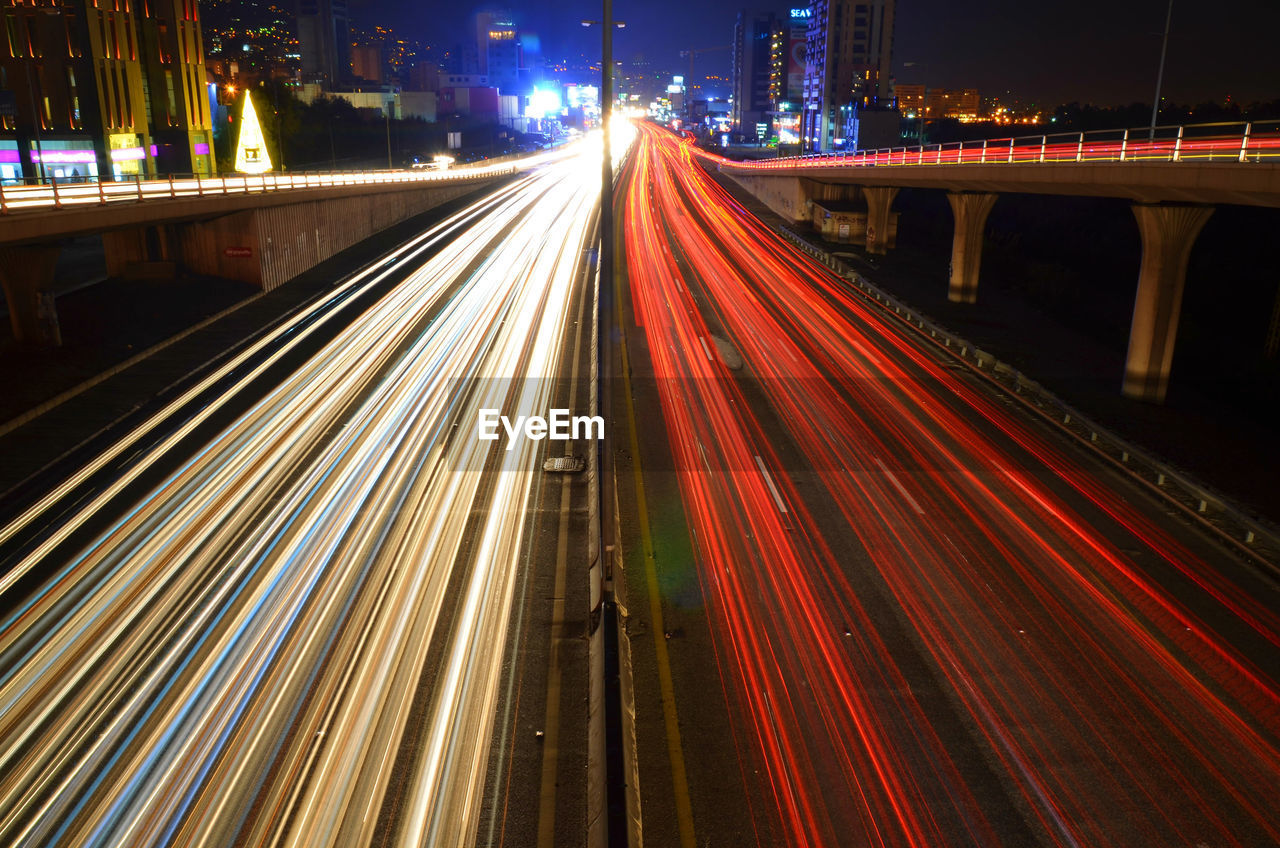 Light trails on bridge in city at night