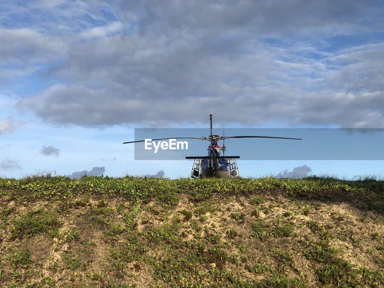 sky, cloud, nature, transportation, land, landscape, environment, mode of transportation, field, rural area, plant, air vehicle, rural scene, vehicle, day, outdoors, no people, prairie, agriculture, grass, plain, helicopter, travel