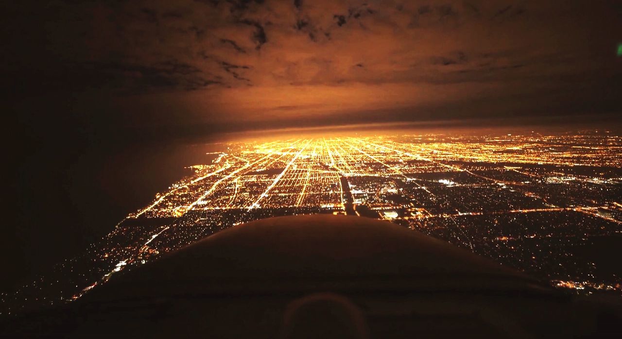 VIEW OF ILLUMINATED CITYSCAPE AT NIGHT