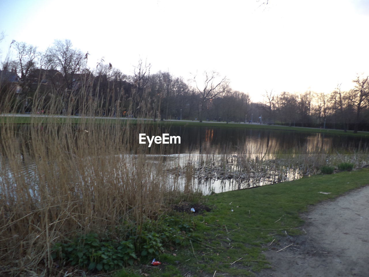 SCENIC VIEW OF CALM LAKE AGAINST SKY