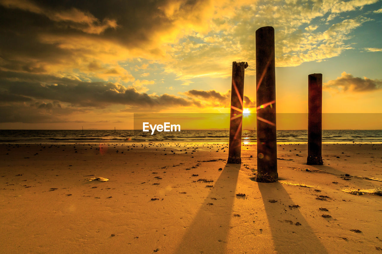 Scenic view of beach against sky during sunset