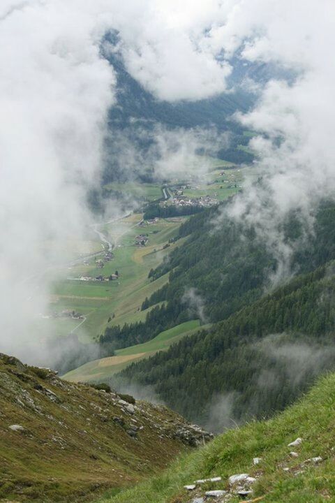 SCENIC VIEW OF MOUNTAINS AGAINST CLOUDY SKY