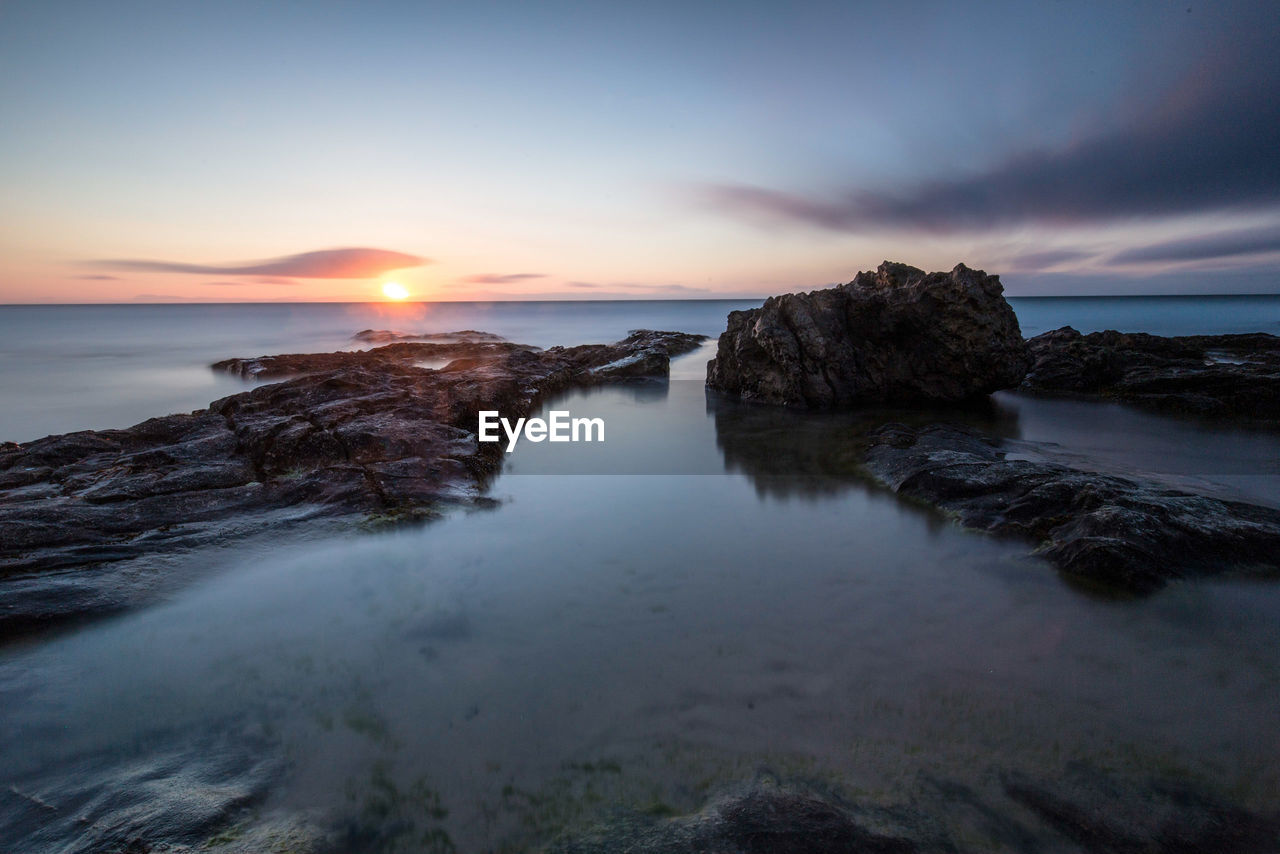 Scenic view of sea against sky during sunset