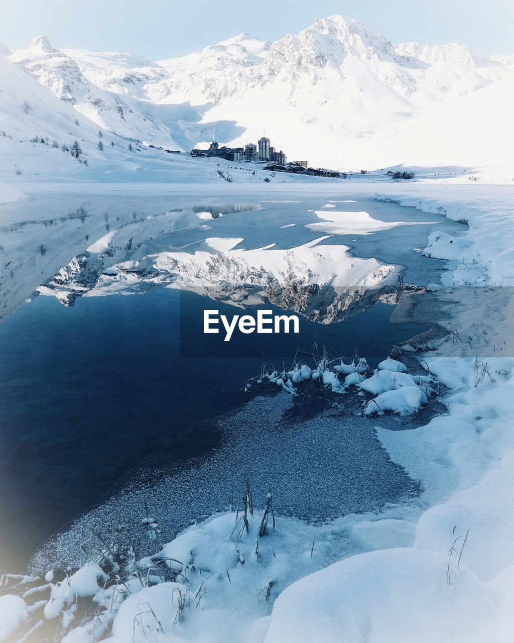 Aerial view of snow covered mountains against sky