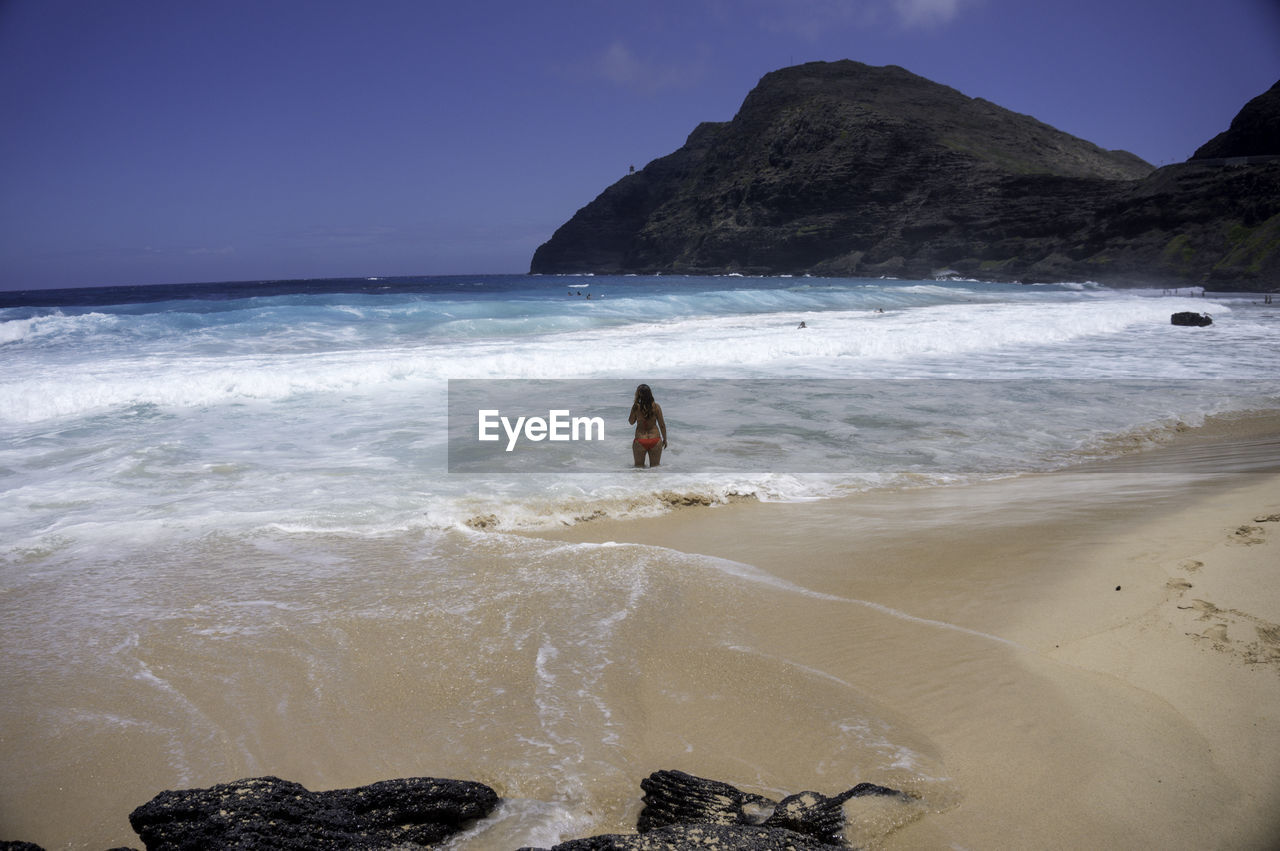 Rear view of woman at beach