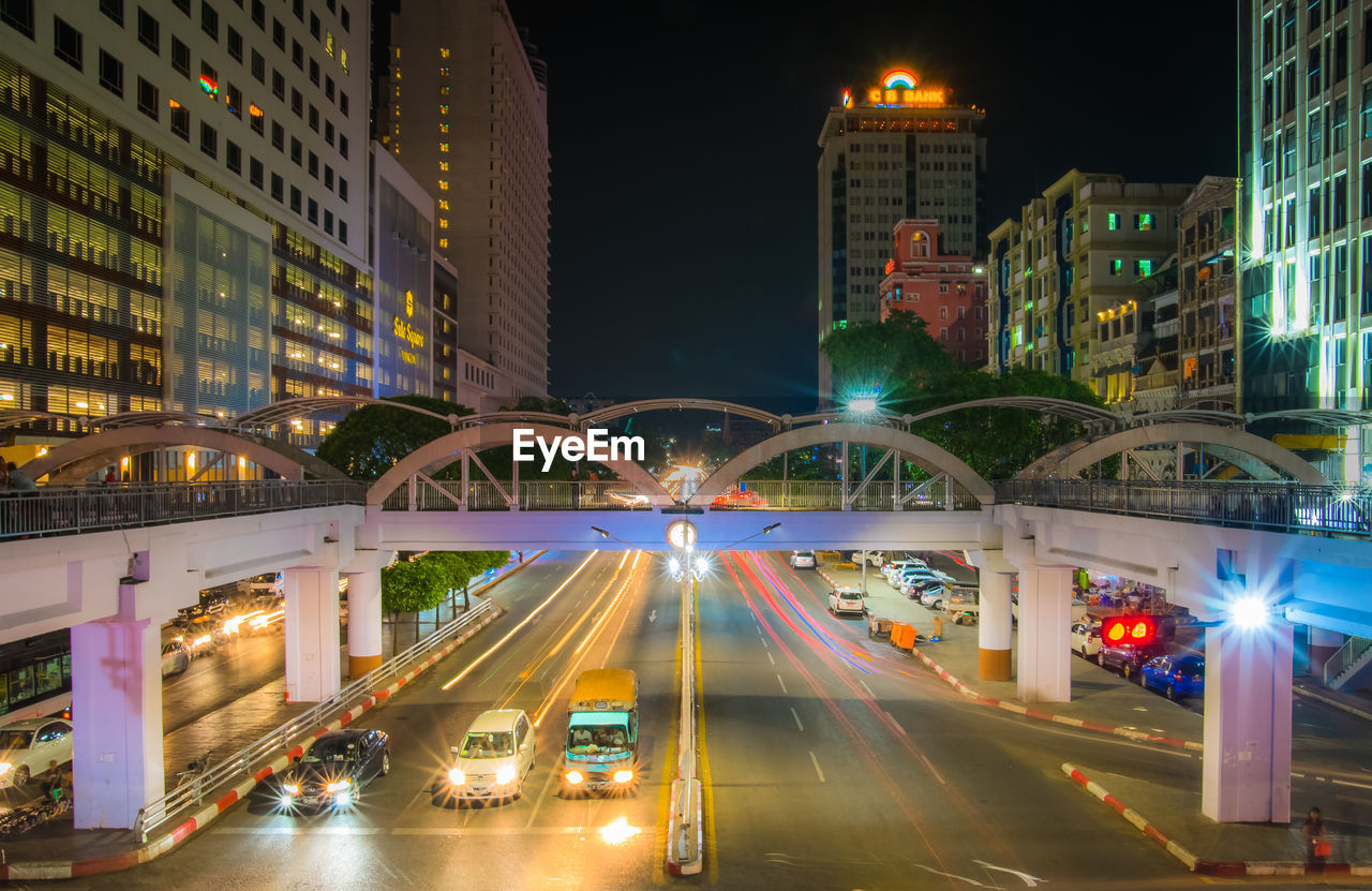 Illuminated city street and buildings at night