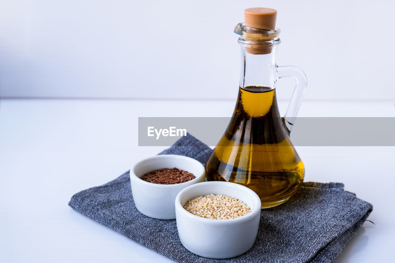 Sesame and flax seeds with oil in glass bottle. healthy food concept. vegan keto diet. healthy eat