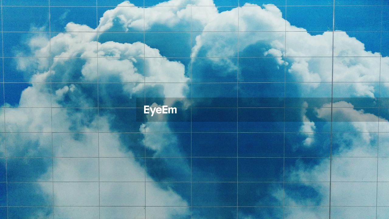 Reflection of cloudy sky on glass