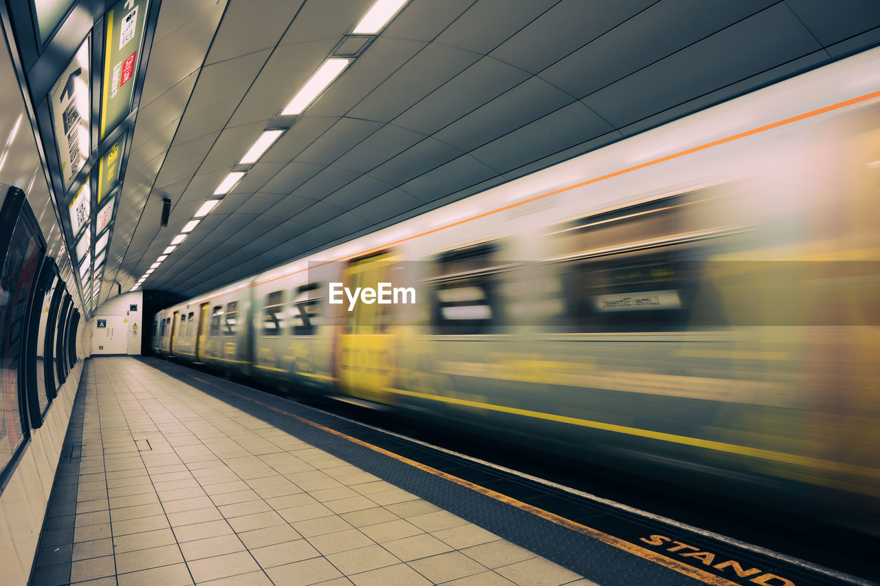 Blurred motion of train at railroad station