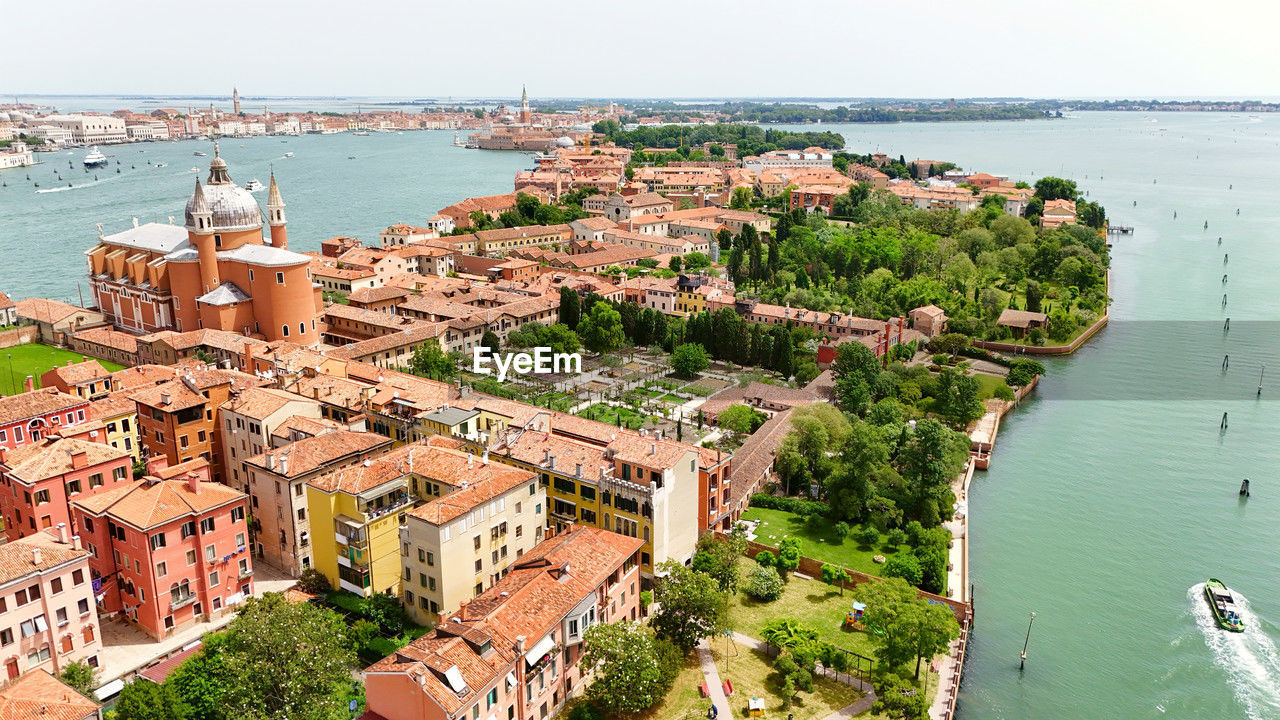 high angle view of buildings by sea