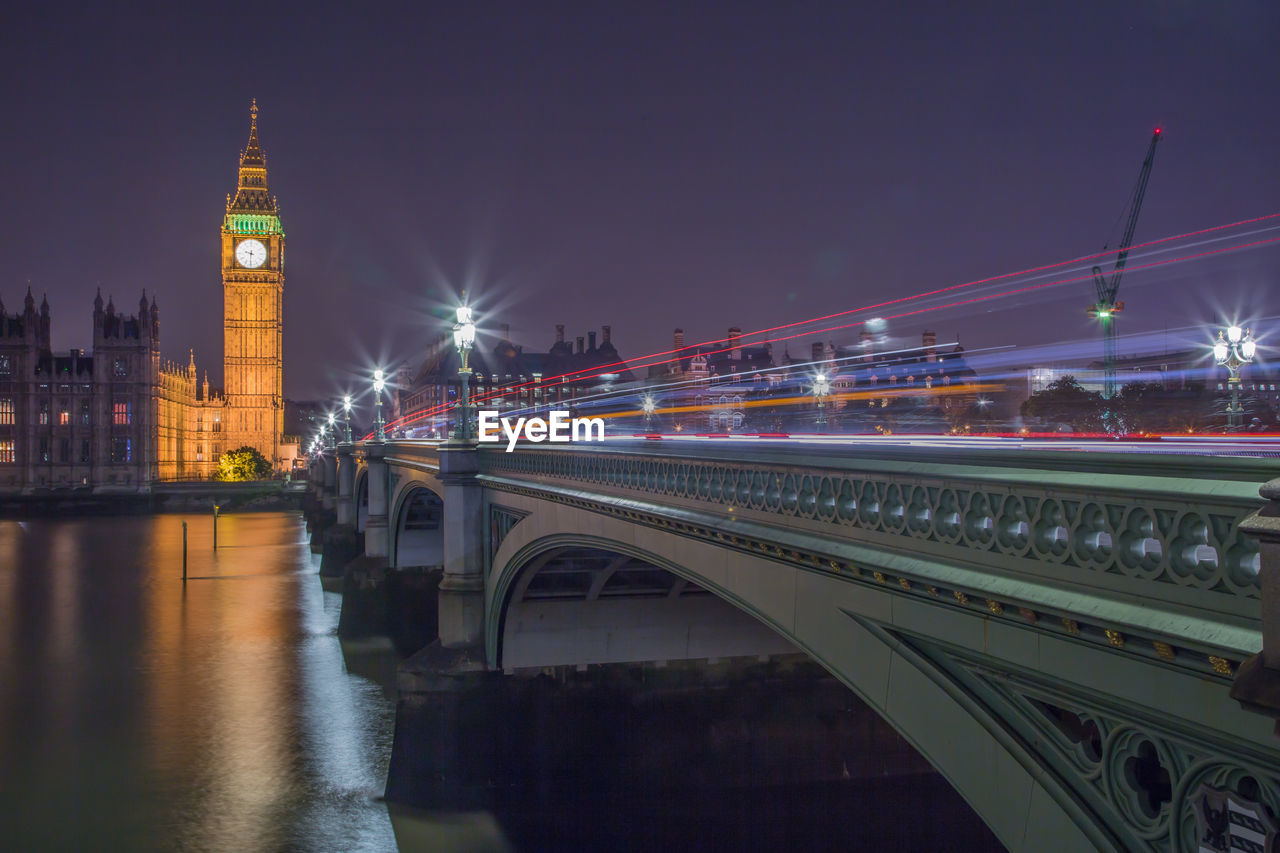 Westminster bridge over thames river against sky at night