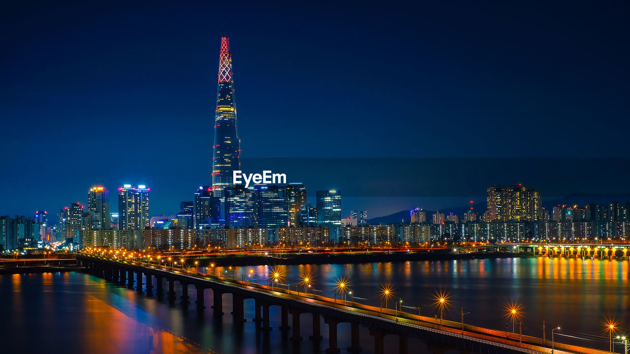 ILLUMINATED MODERN BUILDINGS AT NIGHT