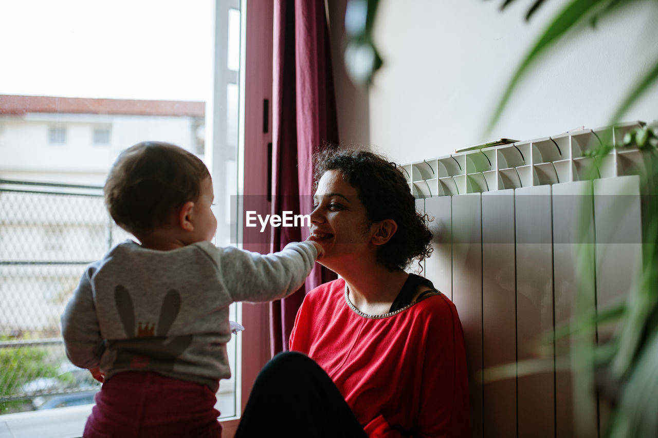 Smiling mother and daughter at home