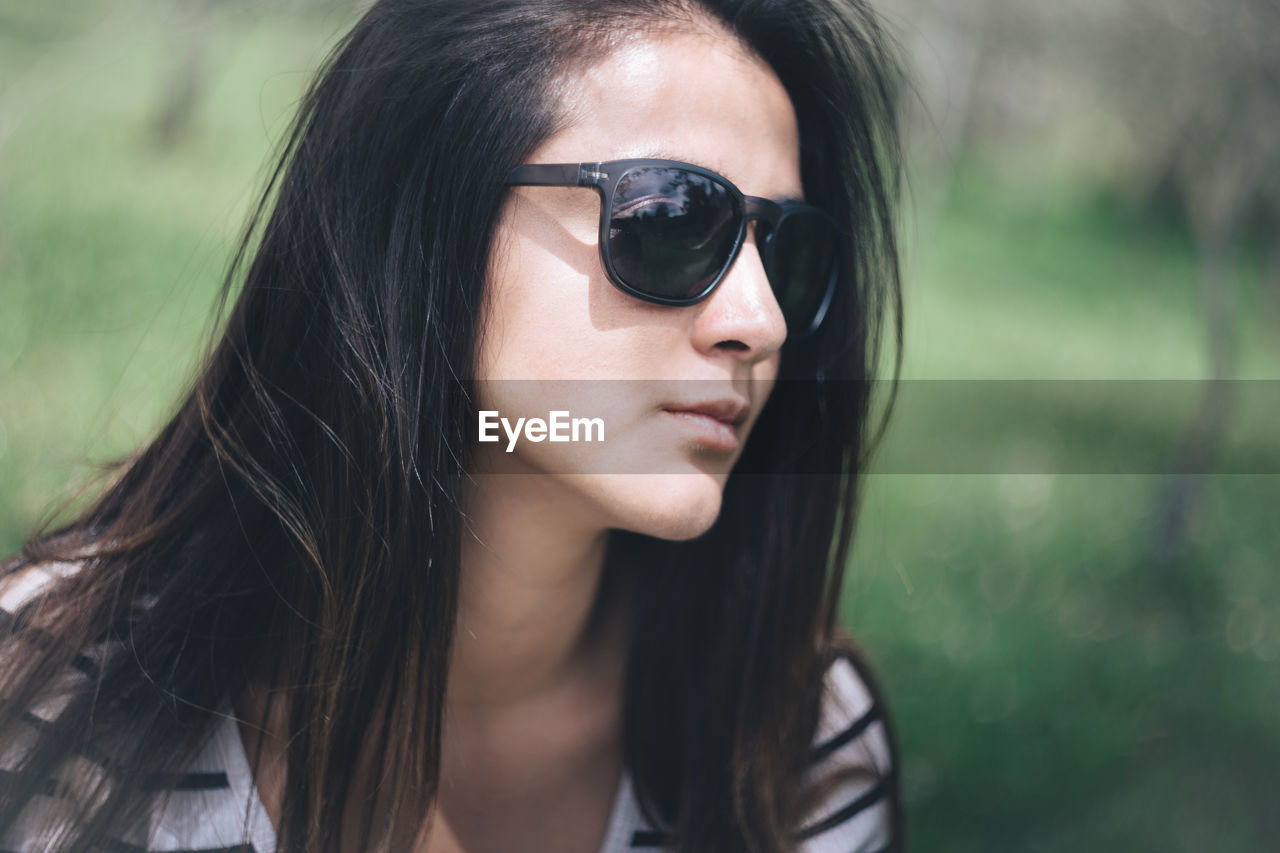 Close-up of young woman wearing sunglasses