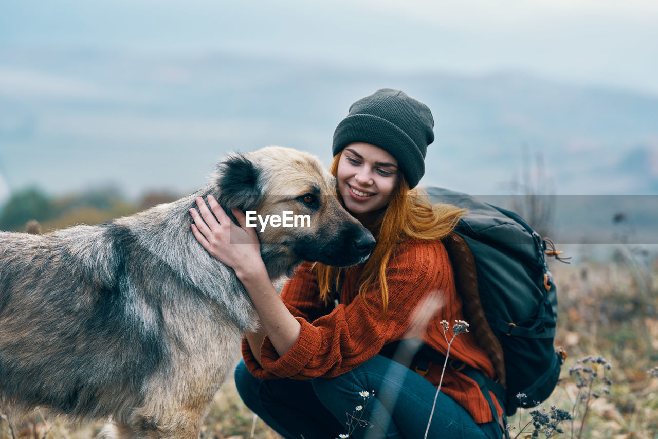 YOUNG MAN WITH DOG ON CAMERA