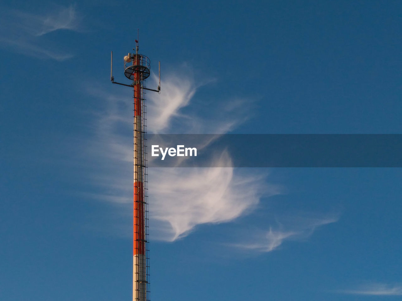 Low angle view of communications tower against sky