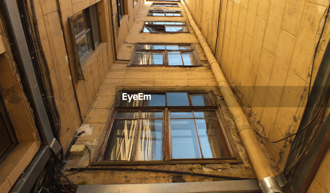 LOW ANGLE VIEW OF WINDOW IN OLD BUILDING