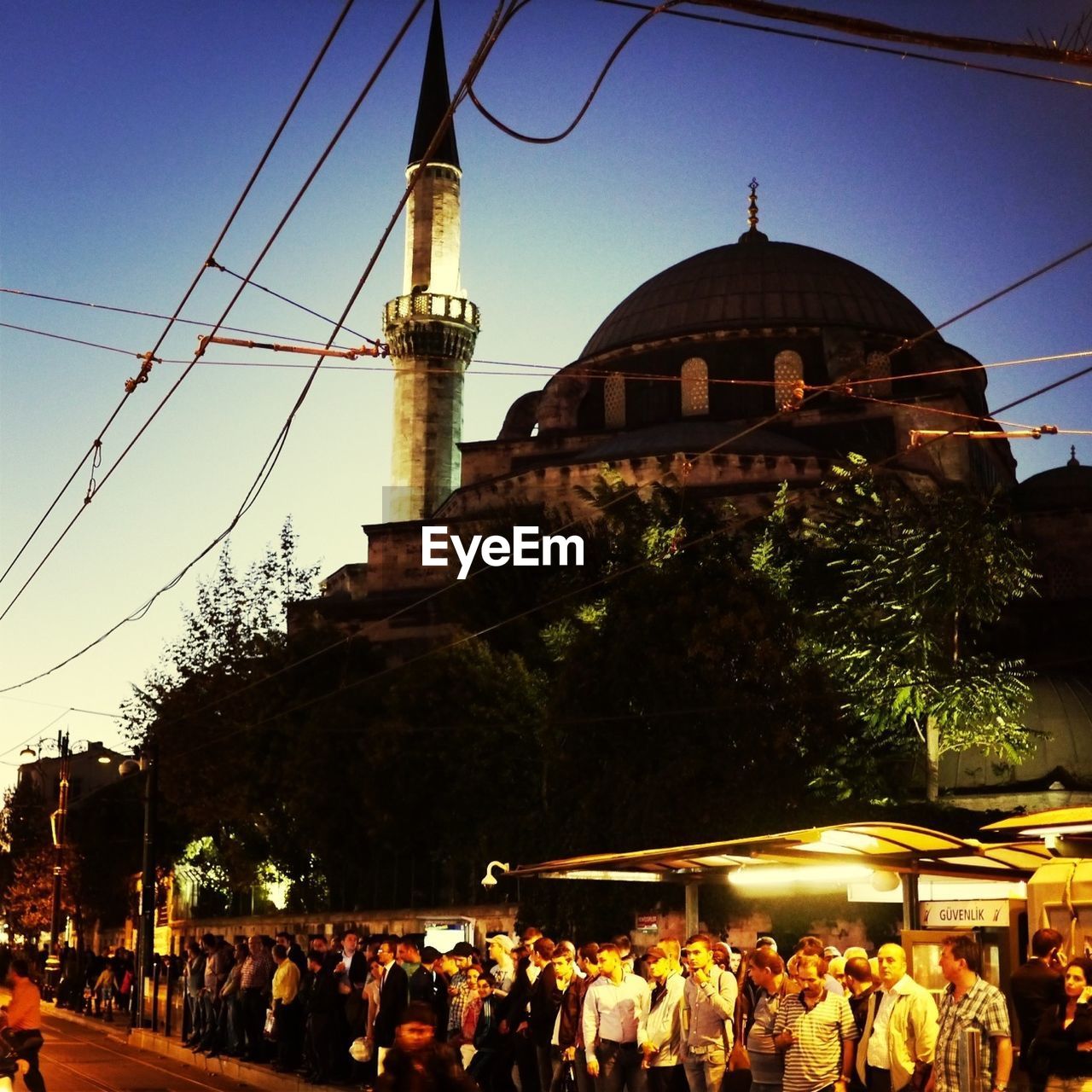 View of mosque and people standing in street